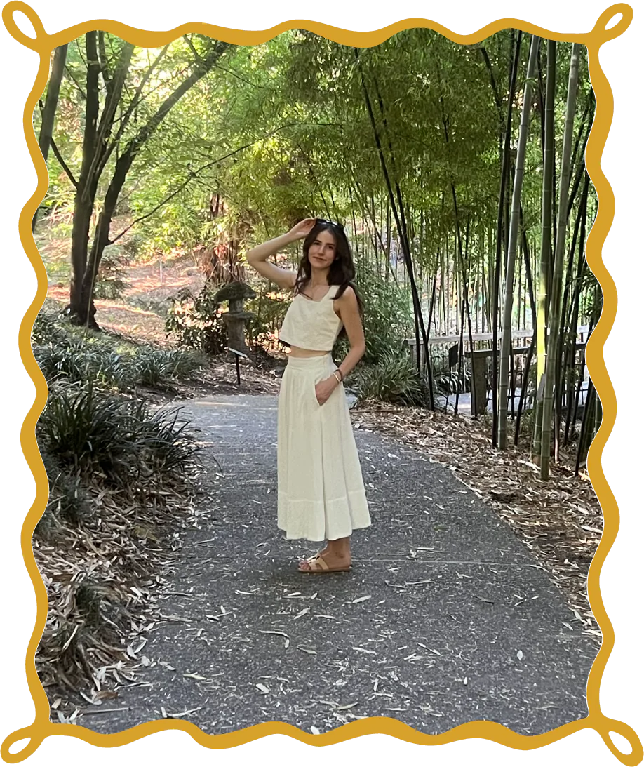 Chloe Schraeder standing on a garden path in athletic wear.